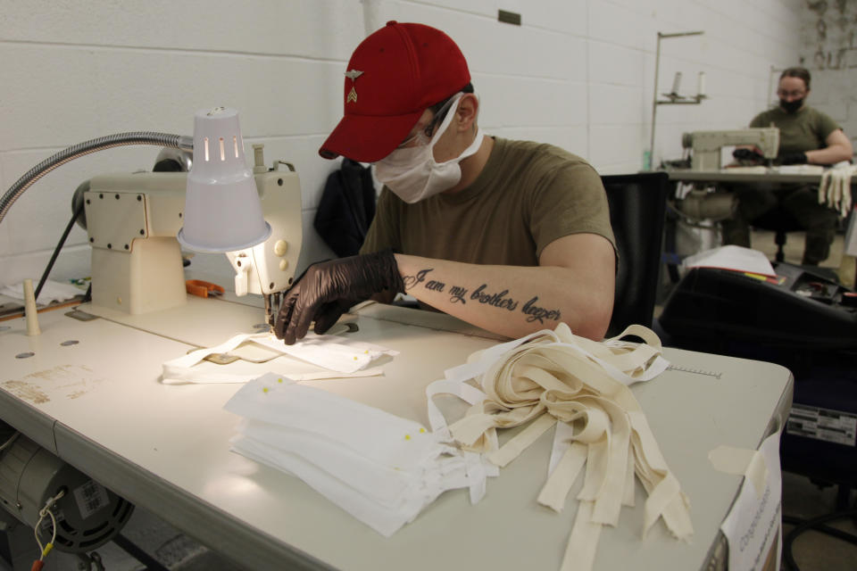 In this April 17, 2020 photo, a U.S. Army paratrooper assigned to the 347th Quartermaster Company sews together a cloth face mask at Fort Bragg, N.C. Parachute riggers are constructing PPE, while continuing to support Fort Bragg's ongoing Airborne operations. (AP Photo/Sarah Blake Morgan)
