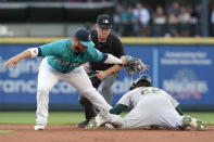 Oakland Athletics' Ramon Laureano, right, is caught stealing second base by Seattle Mariners second baseman Ty France, as umpire Mike Muchlinski watches during the second inning of a baseball game Friday, July 23, 2021, in Seattle. (AP Photo/Ted S. Warren)