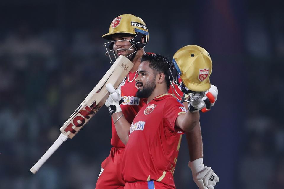 Punjab Kings' Prabhsimran Singh, right, celebrates his century as Sikandar Raza watches during the Indian Premier League cricket match between Delhi Capitals and Punjab Kings in New Delhi, India, Saturday, May 13, 2023. (AP Photo/Surjeet Yadav)