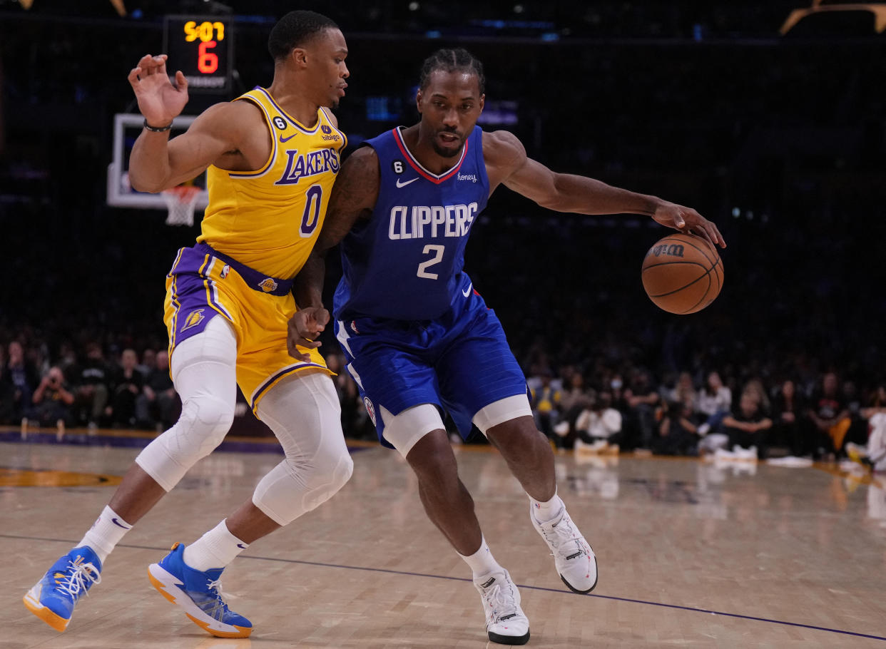 Los Angeles Clippers forward Kawhi Leonard is defended by Los Angeles Lakers guard Russell Westbrook in the second half of their game at Crypto.com Arena in Los Angeles on Oct. 20, 2022. The Clippers defeated the Lakers, 103-97. (Kirby Lee/USA TODAY Sports)