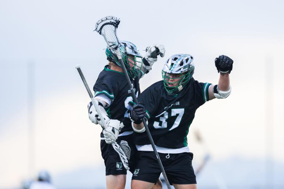 Green Canyon’s Jackson Landon (37) chest bumps teammate Connor Dockery (65) during the 4A boys lacrosse championships at Zions Bank Stadium in Herriman on May 26, 2023. | Ryan Sun, Deseret News