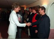 <p>Ahead of the singer's performance at a concert for World AIDS Day in 1993, he met Princess Diana and wore a remarkably tame black suit paired with his AIDS awareness red ribbon. </p>