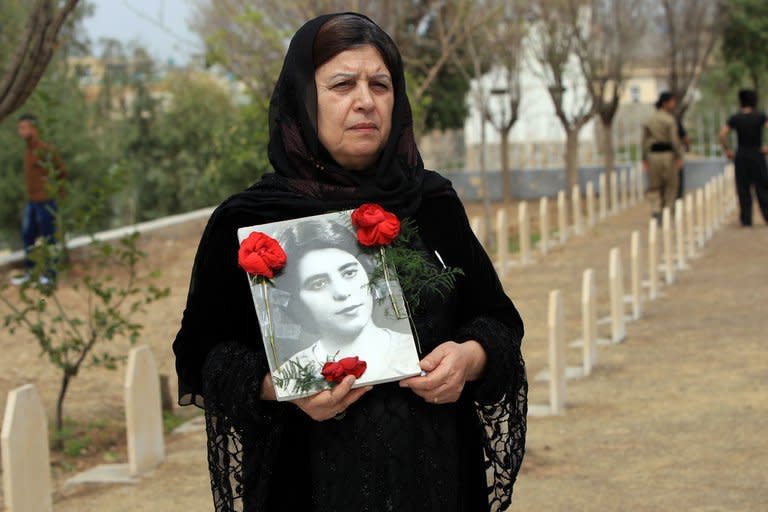 An Iraqi Kurdish woman visits the grave of her sister, who was killed in a gas attack by former Iraqi president Saddam Hussein in 1988, during the 25th anniversary of the attack at the memorial site of the victims in the Kurdish town of Halabja, on March 16, 2013. Hundreds of people joined in sombre commemorations for the 25th anniversary the gassing of thousands of Kurds in Halabja