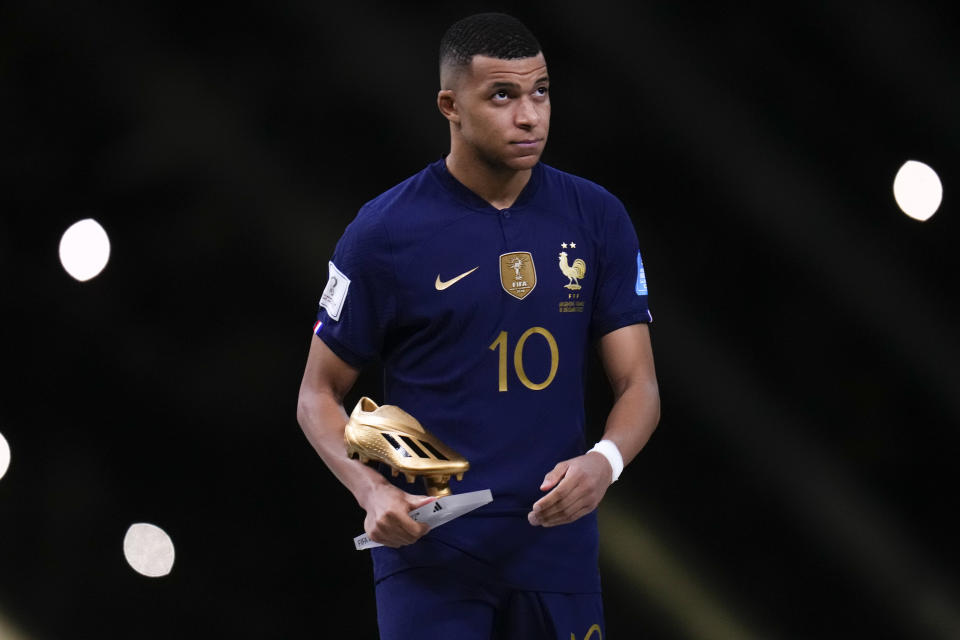 France's Kylian Mbappe the Golden Boot award for top goalscorer of the tournament after the World Cup final soccer match between Argentina and France at the Lusail Stadium in Lusail, Qatar, Sunday, Dec.18, 2022. (AP Photo/Manu Fernandez)