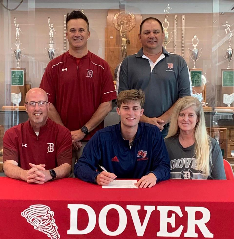 Dover's Ayden Hall signs his letter of intent to attend and play college baseball at Malone University. He is seated between his father Jason and mother Kelly. At back is Dover assistant baseball coach Doug Burtscher and head coach Jeff Fondriest.