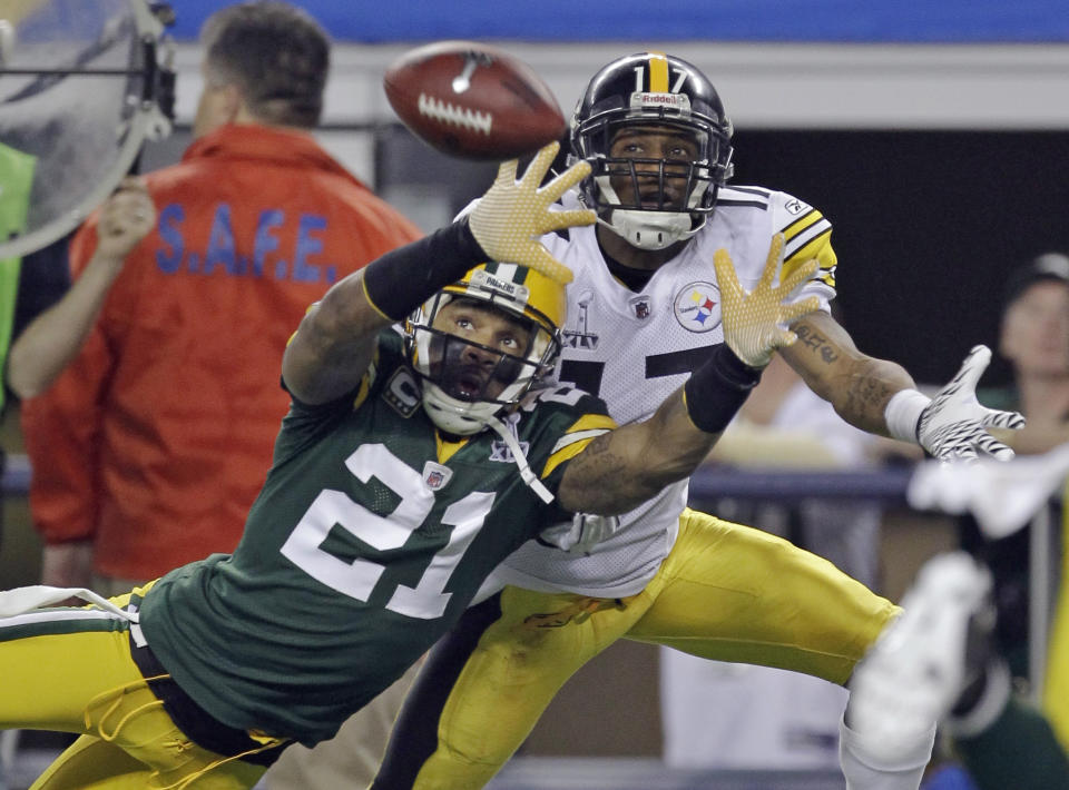 FILE - In this Feb. 6, 2011, file photo, Green Bay Packers' Charles Woodson (21) defends on a pass intended for Pittsburgh Steelers' Mike Wallace during the first half of the NFL football Super Bowl XLV football game in Arlington, Texas, in this Sunday, Feb. 6, 2011, file photo. The pass fell incomplete. Charles Woodson beat out Peyton Manning for a prestigious college award. Something called the Heisman Trophy. On Saturday, Feb. 6, 2021, they likely will share an even more impressive football honor: entry into the Pro Football Hall of Fame. (AP Photo/Dave Martin, File)