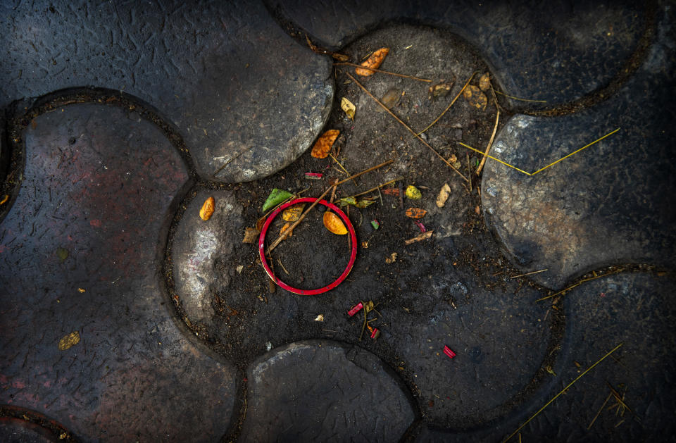 A bangle of a deceased COVID-19 victim lies in a cremation ground in Gauhati, India, Friday, July 2, 2021. The personal belongings of cremated COVID-19 victims lie strewn around the grounds of the Ulubari cremation ground in Gauhati, the biggest city in India’s remote northeast. It's a fundamental change from the rites and traditions that surround death in the Hindu religion. And, perhaps, also reflects the grim fears grieving people shaken by the deaths of their loved ones — have of the virus in India, where more than 405,000 people have died. (AP Photo/Anupam Nath)