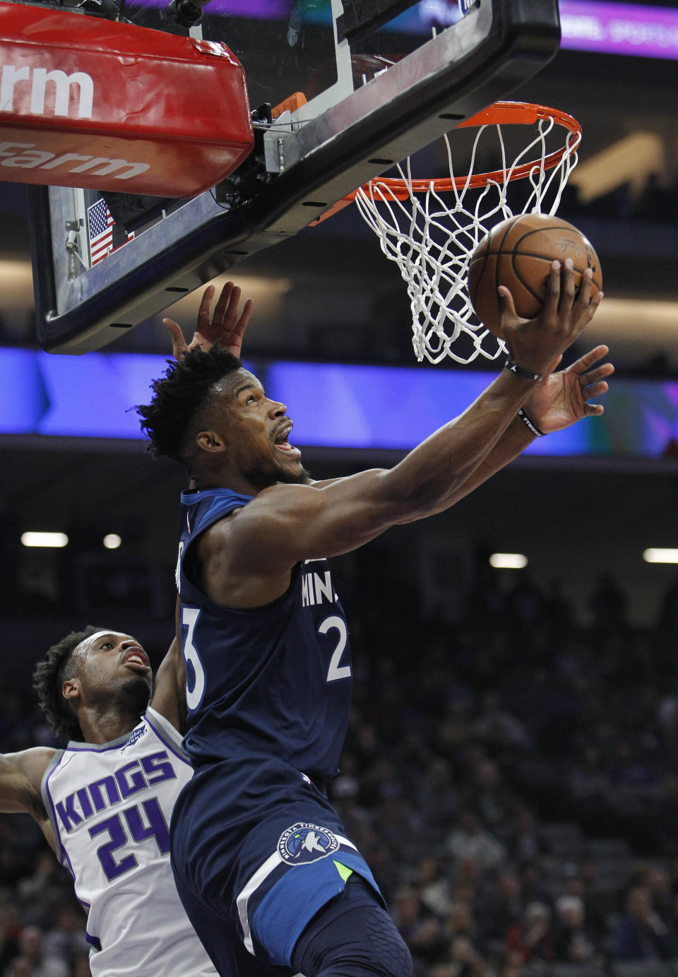 Minnesota Timberwolves guard Jimmy Butler (23) gets around Sacramento Kings guard Buddy Hield (24) for a basket during the first half of an NBA basketball game in Sacramento, Calif., Friday, Nov. 9, 2018. (AP Photo/Steve Yeater)