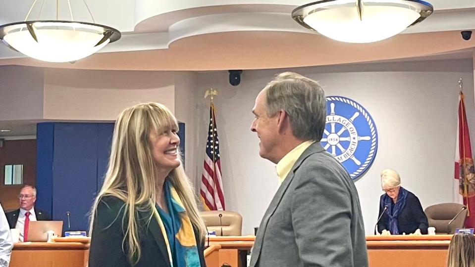 Former North Palm Beach Mayor David Norris congratulates Council Member Kristin Garrison before she is sworn in on March 14, 2024, in North Palm Beach.