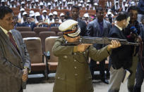 Assam police director general Bhaskar Jyoti Mahanta, checks arms and ammunition handed over by cadres of different rebel groups during a surrender ceremony in Gauhati, India, Thursday, Jan. 23, 2020. More than 600 insurgents belonging to eight different rebel groups have surrendered to Indian authorities in this troubled northeastern state, responding to the government’s peace initiative to rejoin mainstream society. (AP Photo/Anupam Nath)
