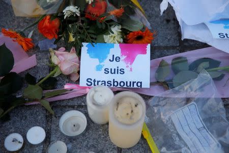 The message "I am Strasbourg" is seen among flowers and candles at the Place Kleber in tribute to the victims of the deadly shooting in Strasbourg, France, December 13, 2018. REUTERS/Vincent Kessler