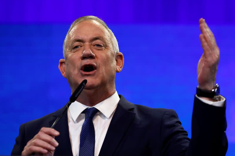 Blue and White party leader Benny Gantz gestures as he speaks to supporters following the announcement of exit polls in Israel's election at the party's headquarters in Tel Aviv