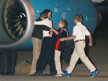 Jeffrey Fowle, who was detained for more than seven months in North Korea, is greeted by his family after arriving at Wright Patterson Air Force Base in Fairborn, Ohio October 22, 2014. REUTERS/Jim Witmer/Dayton Daily News/MCT