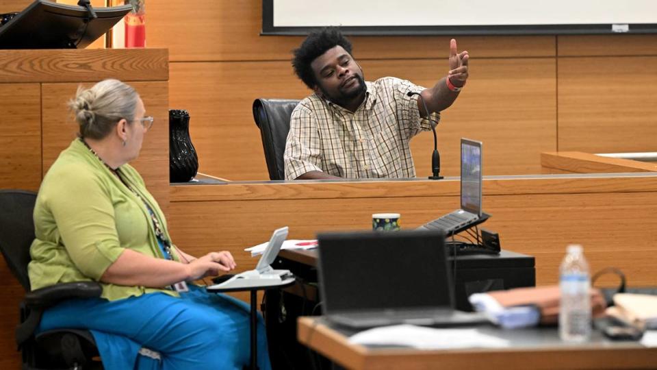 Joseph Brice demonstrates a gesture made in the a nightclub called The Hall between two groups of people on the night Jerome Miller was shot in 2019, while testifying at the Manatee County Judicial Center on Tuesday, April 9, 2024. Tiffany Tompkins/ttompkins@bradenton.com