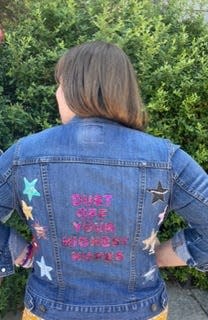 Juliette Holder shows off the jacket she wore to Taylor Swift's 2023 Eras Tour.