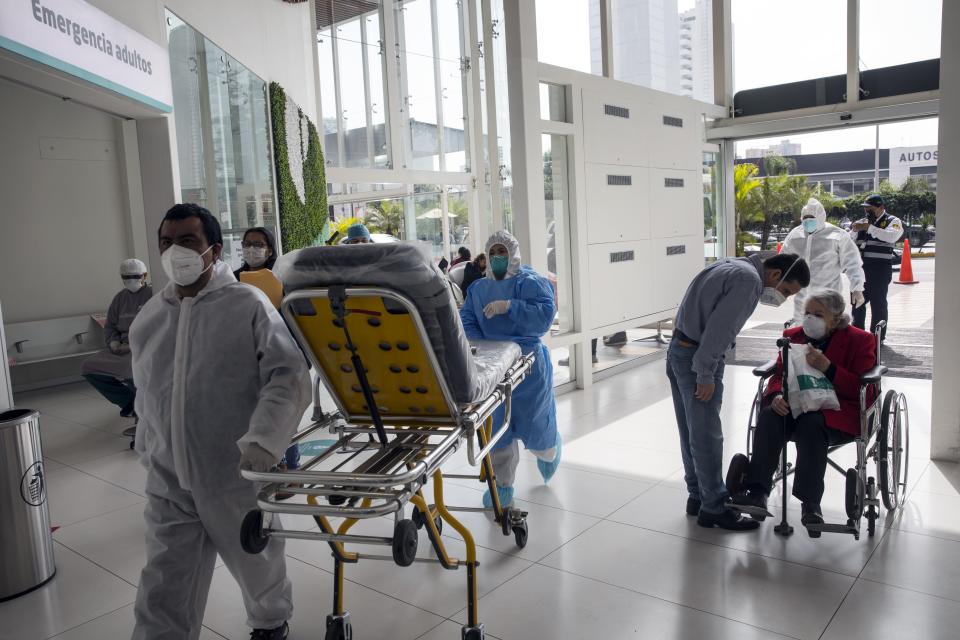 Nurses and patients gather at the emergency entrance of the private Ricardo Palma hospital amid the new coronavirus pandemic, in Lima, Peru, Tuesday, July 7, 2020. (AP Photo/Rodrigo Abd)