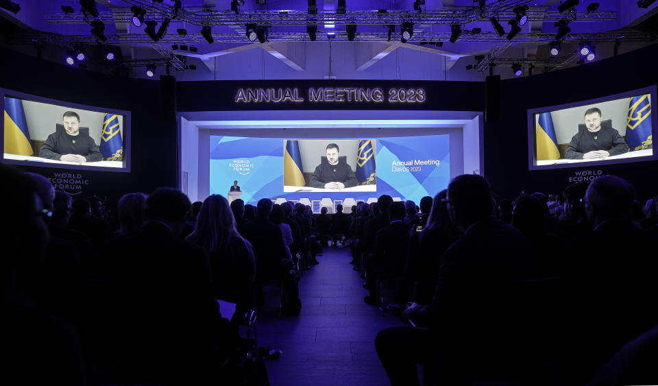 President Volodymyr Zelenskyy of Ukraine talks from a video screen to participants at the World Economic Forum in Davos, Switzerland on Wednesday, Jan. 18, 2023. The annual meeting of the World Economic Forum is taking place in Davos from Jan. 16 until Jan. 20, 2023. (AP Photo/Markus Schreiber)