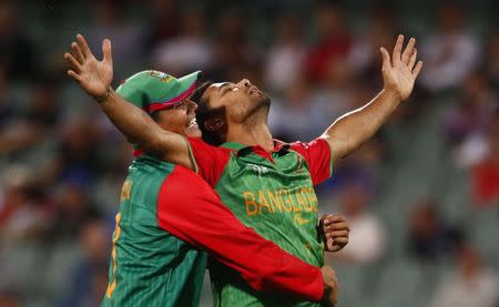 Bangladesh captain and bowler Masrafe bin Mortaza (R) reacts with team mate Taskin Ahmed after England Batsman Joe Root was caught behind by wicket keeper Mushfiqur Rahim during their Cricket World Cup match in Adelaide, March 9, 2015. REUTERS/David Gray