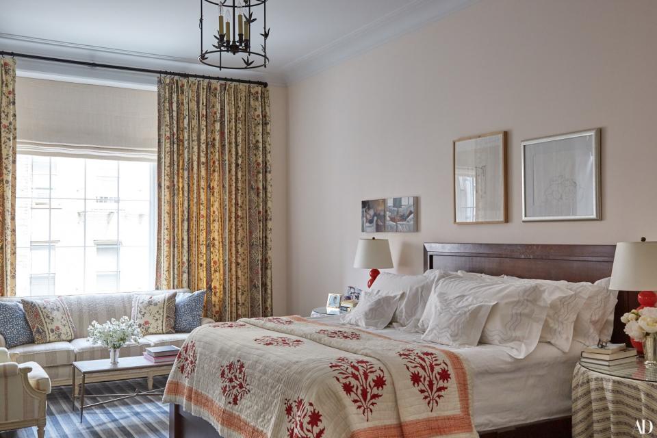 In the master bedroom, an E.F. Chapman lantern hangs over the custom bed with D. Porthault linens and a Simrane quilt. Curtains of a Braquenié cotton; Baguès cocktail table.