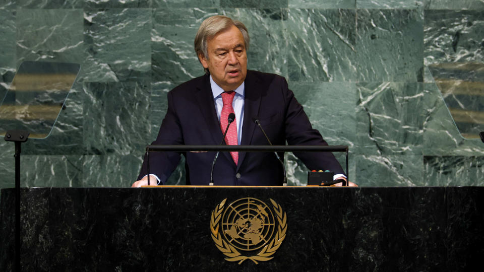 Secretary-General António Guterres at the microphone at a podium with the United Nations seal, against a backdrop of green marble.