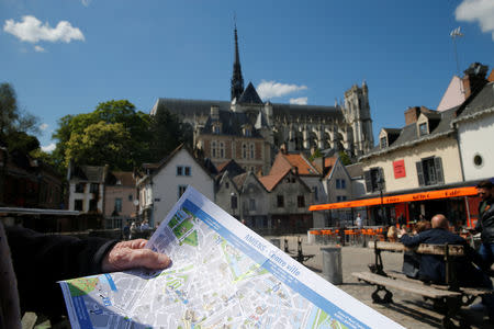 A tourist holds a map of the city of Amiens, France, May 16, 2019. Picture taken May 16, 2019. REUTERS/Pascal Rossignol