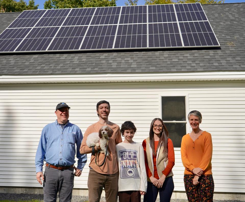 Sam Zuckerman, of Maine Solar Solutions, poses for a photo with Gaberiel, Alicia and Derek Harmon along with Amy Nucci, executive director of Habitat for Humanity.