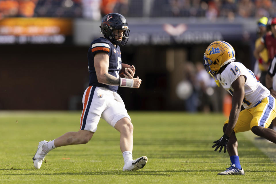 Virginia quarterback Brennan Armstrong (5) runs the ball against Pittsburgh during the second half of an NCAA college football game in Charlottesville, Va., Saturday, Nov. 12, 2022. (AP Photo/Mike Kropf)