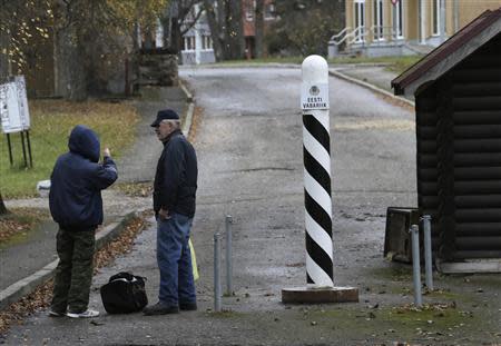 People chat near a border crossing point with Estonia in Valka October 25, 2013. REUTERS/Ints Kalnins