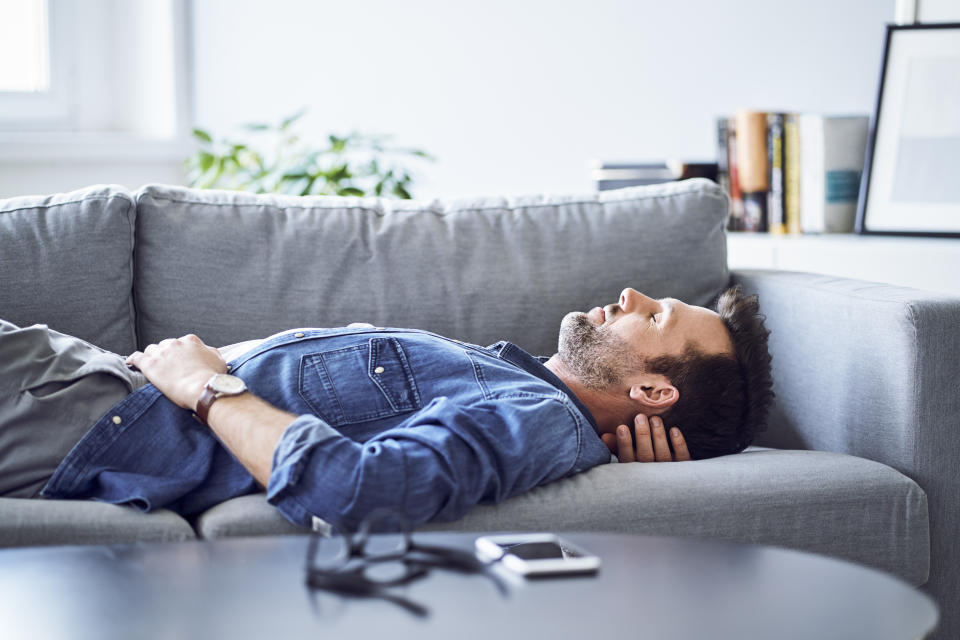 Relaxed man sleeping on sofa