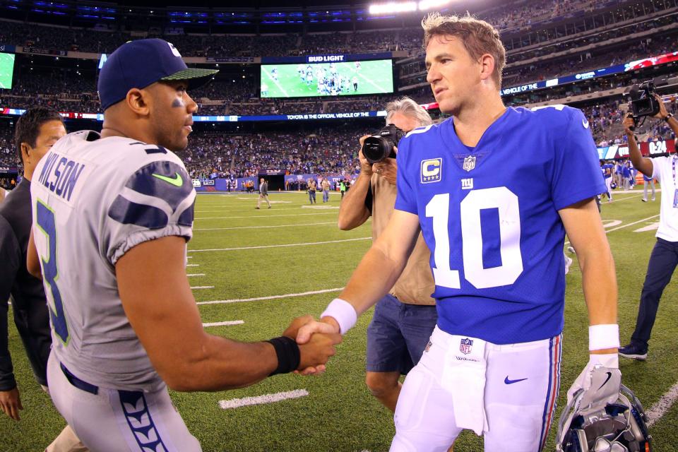 QB Russell Wilson, then with the Seahawks, shakes hands with former Giants quarterback Eli Manning (10) after a game at MetLife Stadium in 2017.