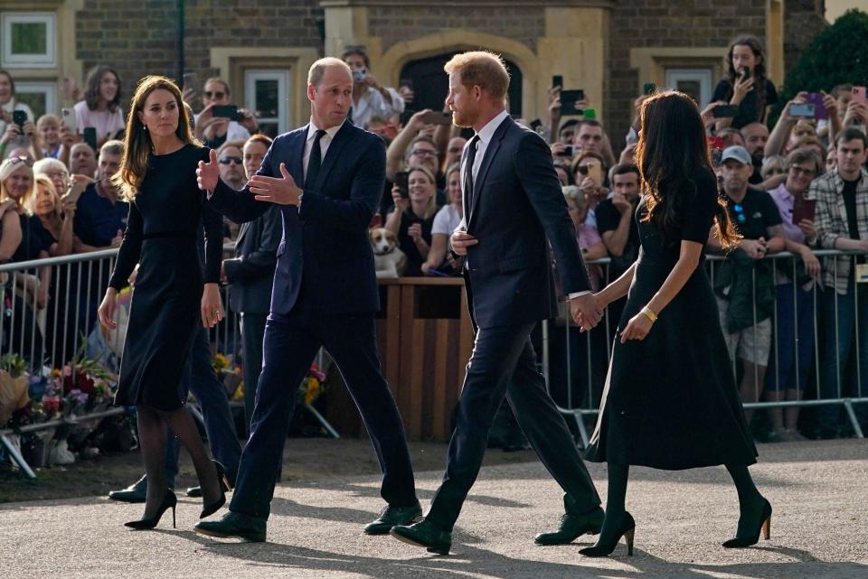 Mandatory Credit: Photo by Alberto Pezzali/AP/Shutterstock (13381171b) Britain's Prince William and Kate, Princess of Wales, left, and Britain's Prince Harry and Meghan, Duchess of Sussex walk to greet the crowds after viewing the floral tributes for the late Queen Elizabeth II outside Windsor Castle, in Windsor, England Royals, Windsor, United Kingdom - 10 Sep 2022