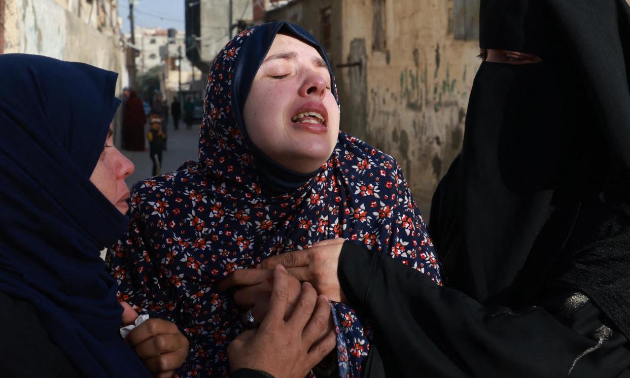 <span>Rania Abu Anza (C) mourns the deaths of her twin babies before their burial in Rafah, southern Gaza, on Monday.</span><span>Photograph: Mohammed Abed/AFP/Getty Images</span>