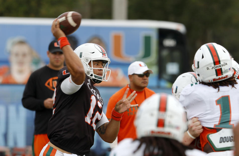 Quarterback Malik Rosier (12) of the Miami NCAA college football team throws as the team practiced in Davie, Fla., Wednesday, Dec. 27, 2017, for the Orange Bowl to be played against Wisconsin on Dec. 30. (AP Photo/Joe Skipper)