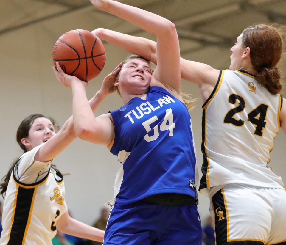 Tuslaw's Breanna McCabe, center, is fouled making a shot defended by Crestview's Addison Rhodes, left, and Luvrain Gaskins, right, Wednesday.