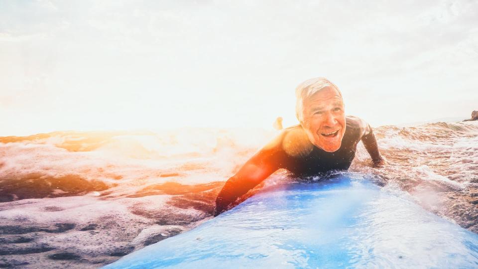 older man surfing in the ocean