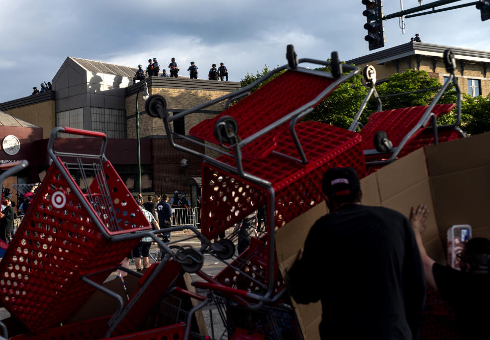 Protesters use shopping carts as a barricade as they confront police near the 3rd precinct on May 27. | Stephen Maturen—Getty Images