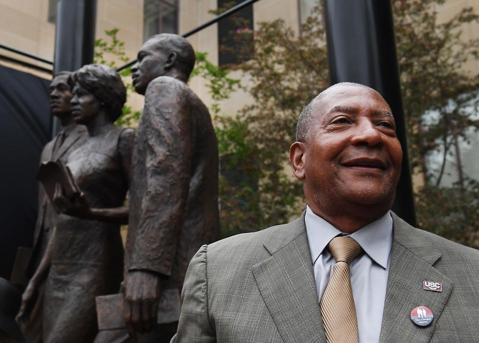 A statue unveiling Friday, April 19, 2024 honors the first three Black students to enroll in the University of South Carolina
post-reconstruction. 
Greenville native Robert G. Anderson joins Henrie Monteith Treadwell and James L. Solomon Jr., on the desegregation monument near the McKissick Museum. The University of South Caroina Alexander English and basketball standout, right, attended the event.