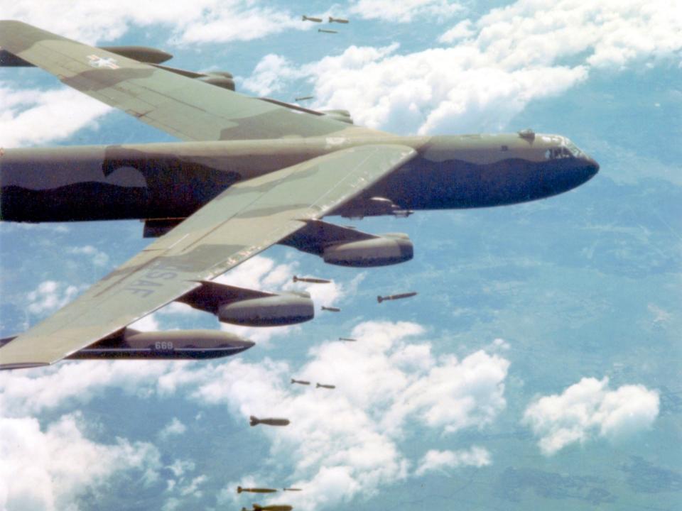 A US Air Force Boeing B-52 Stratofortress dropping bombs over Vietnam.