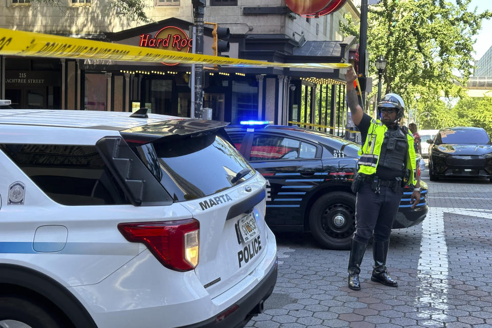 Police respond to the scene of a shooting outside the Peachtree Center complex, Tuesday, June 11, 2024, in downtown Atlanta. (AP Photo/Jeff Amy)