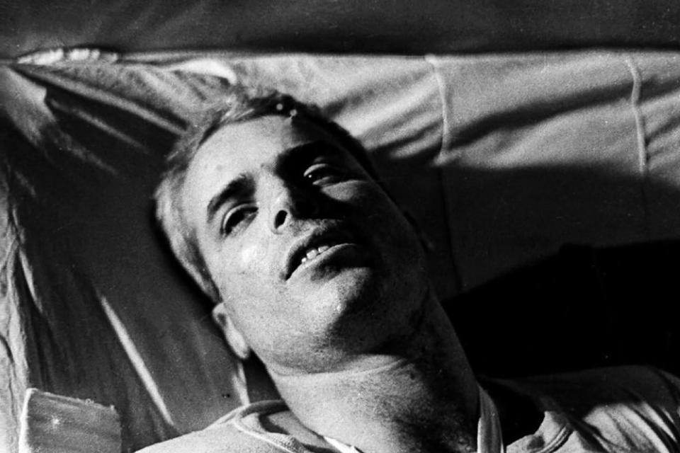 Then Navy Lieutenant Commander John McCain lying on a bed in a hospital in Hanoi, Vietnam in 1967.