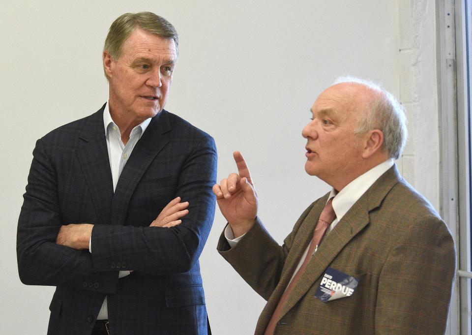 Marshall Bandy, right, greets former U.S. Sen David Perdue at the northwest Georgia headquarters for Voters Organized for Trusted Election Results in Georgia, in Ringgold, Ga., Thursday, April 14, 2022. Perdue is building his campaign around former President Donald Trump and veering to the right as he tries to unseat Republican Gov. Brian Kemp in a May 24 GOP primary. (Matt Hamilton/Chattanooga Times Free Press via AP)