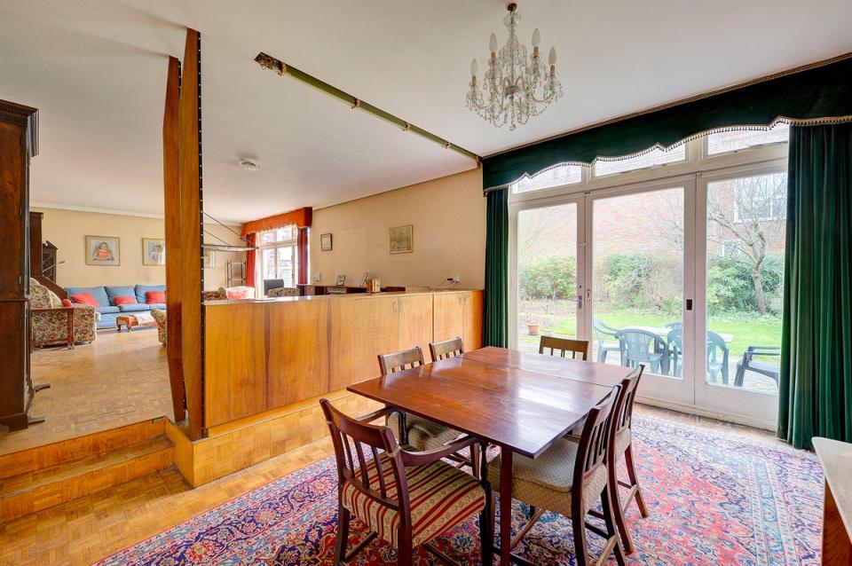 The oak veneer room divider and parquet floor are all original (Savills)