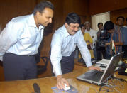 Indian Information Technology and Communication Minister Dayanidhi Maran (R) works on a computer as Member of Parliament (MP) and Vice-Chairman of the telecommunications and petroleum Reliance group Anil Ambani (L) looks on, at the Communication Ministry in New Delhi, 06 August 2004. Maran launched 06 August the Indian Global Communications platform website, describing it as "a technological initiative which will encourage new standards of transparency in public life". AFP PHOTO/RAVEENDRAN