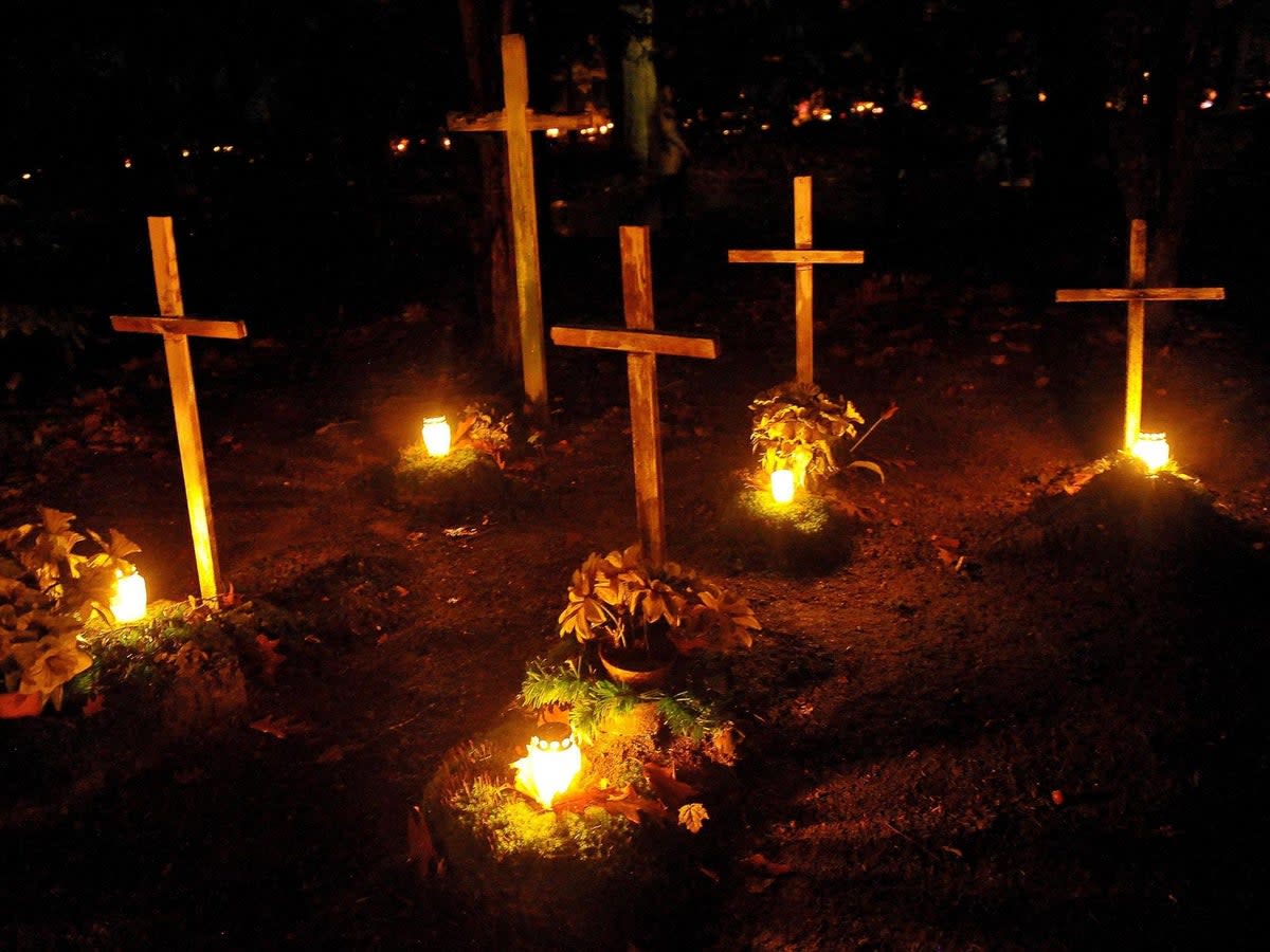 Candles burn on All Saints' Day at the Central Cemetery in Szczecin, Poland (Marcin Bielecki/EPA-EFE/Rex)