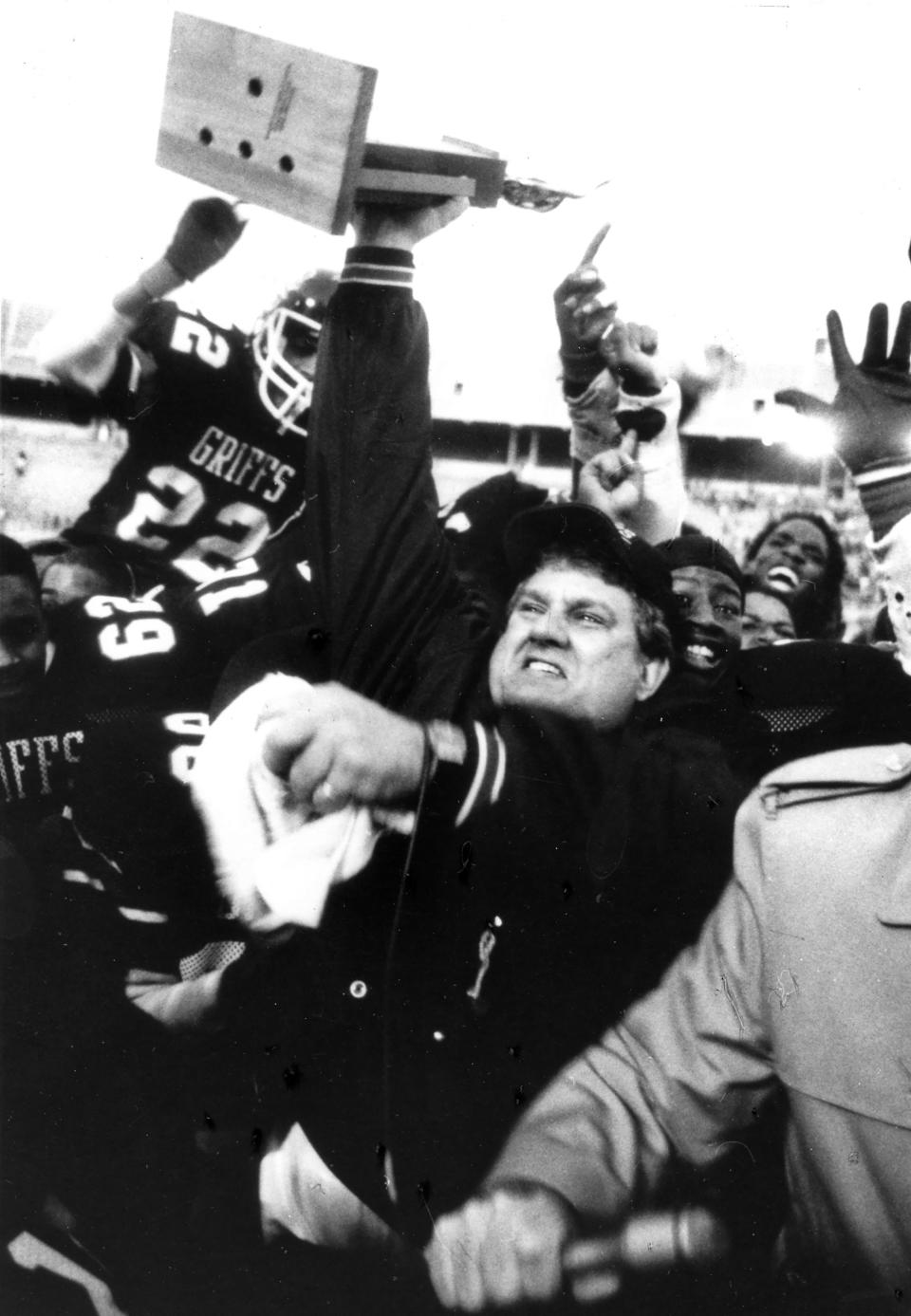 The late Tim Flossie celebrates with his Buchtel players after the 1988 Division II state championship game on Dec. 2, 1988.