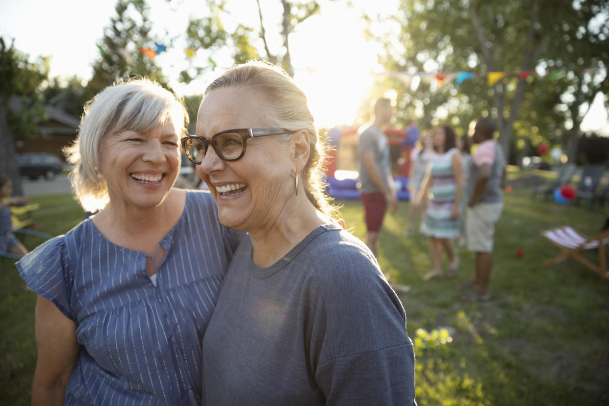 Happy, carefree senior women friends at summer neighborhood block party in park