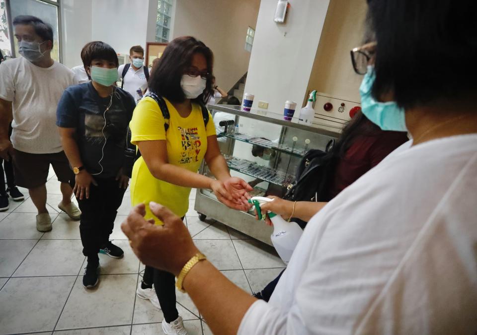 Catholics go through containment protocols including body-temperature measurement and hands-sanitisation before entering the Saint Christopher Parish Church, Taipei City, Taiwan, 26 July 2020. Complying with health advices from the government to stem the spread of the coronavirus Covid-19, staff members of the church also set out the limited number of people allowed to enter the premises to 80 for each session in order to minimise contacts between the believers. (Photo by Ceng Shou Yi/NurPhoto via Getty Images)