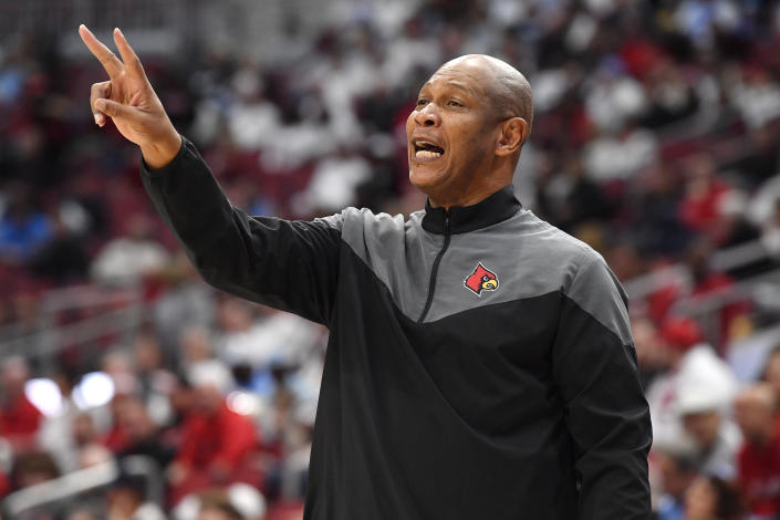 Louisville head coach Kenny Payne sends a play in to his team during the first half of an NCAA college basketball game against North Carolina in Louisville, Ky., Saturday, Jan. 14, 2023. North Carolina won 80-59. (AP Photo/Timothy D. Easley)