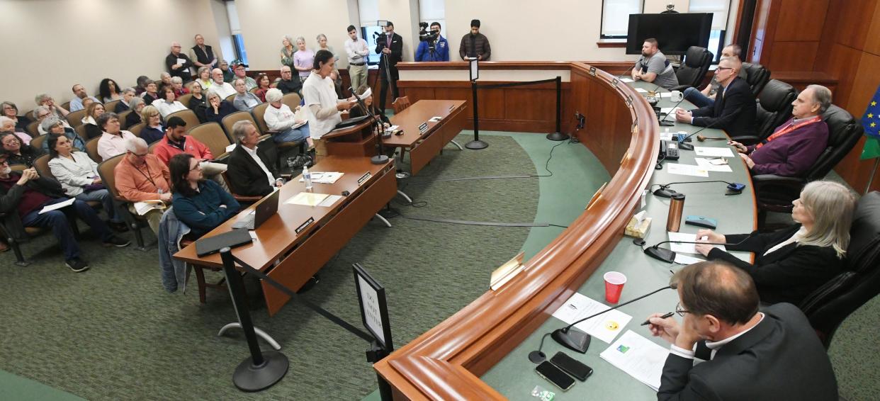 Juan Llarena, at podium, center, addresses Erie County Council during a special meeting in Erie.