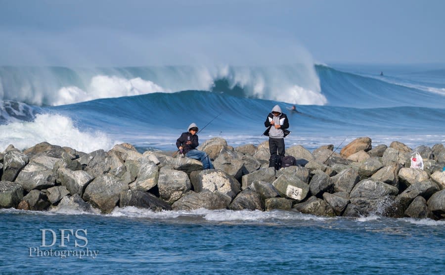 Fishermen wait for a bite while surfers catch waves at Moss Landing on Dec. 27, 2023. (Photo by Dan Sedenquist)